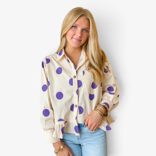 Polka dot ruffle hem shirt in cream with purple dots, button front and feminine ruffle hem, close up view