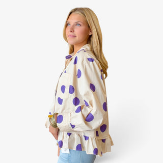 Cream and purple polka dot ruffle hem shirt with long sleeves and relaxed silhouette, side view