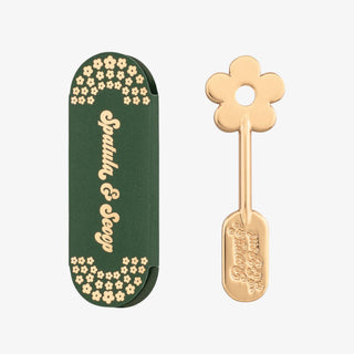 Poppy & Pout Lip Care Spatula in gold with flower handle and protective storage sleeve on white background