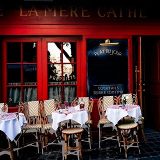 Paris coffee table book interior photography featuring a classic red French café with sidewalk tables and bistro chairs, page view