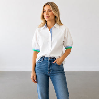 White puff sleeve button down top with blue collar and green contrast trim front view styled with jeans
