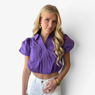 Purple game day cropped shirt with puff sleeves, chest pockets, elastic hem and contrast topstitching shown from the front