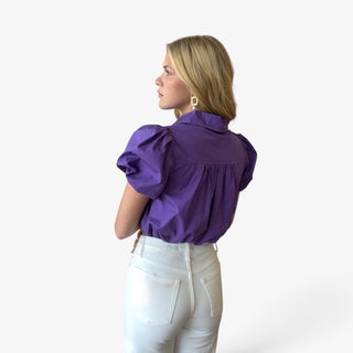 Purple puff sleeve cropped shirt with a relaxed silhouette and gathered elastic hem shown from the back