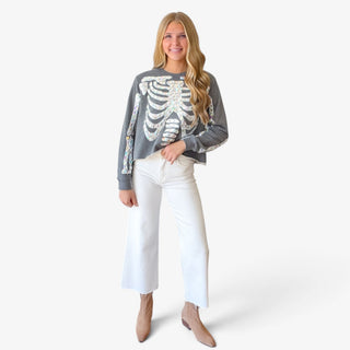Queen of Sparkles charcoal skeleton sweatshirt with iridescent jeweled rib cage and bone details, full front view