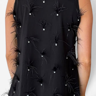 Queen of Sparkles LSU black sequin tiger dress with scattered black feather tufts and sparkling rhinestone accents, close-up view