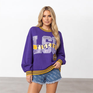 Queen of Sparkles LSU Metallic Banner Sweatshirt front view in purple with metallic LSU graphic, gold Tigers banner, striped trim, and tiger patch.
