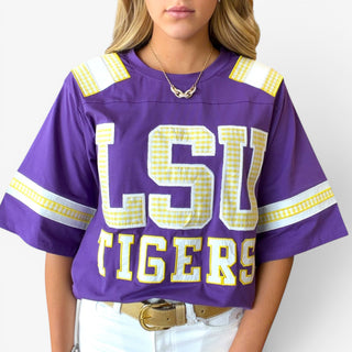 Queen of Sparkles LSU oversized jersey in purple with gold gingham LSU Tigers lettering, front close-up view