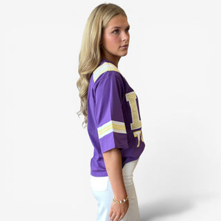 Queen of Sparkles LSU oversized jersey showing the relaxed fit, striped sleeve accents, and longer hem, side view