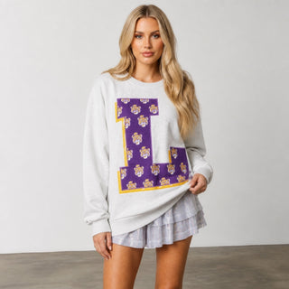 Queen of Sparkles LSU oversized sweatshirt featuring a large purple L with gold trim and repeating tiger mascots, close front view