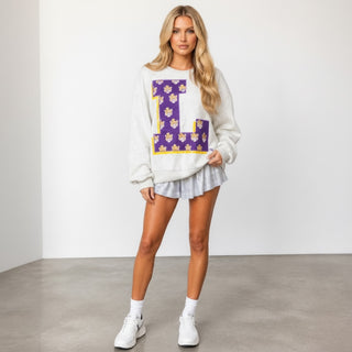 Queen of Sparkles LSU oversized letter sweatshirt in heather gray with a purple tiger-print L, styled with a silver skirt and sneakers, front view