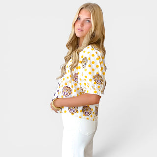 Side view of Queen of Sparkles LSU polka dot top showing gold polka dot side and puff sleeves