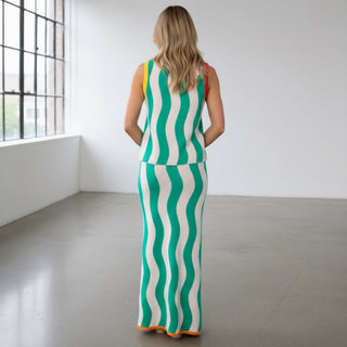 Queen of Sparkles teal midi knit skirt with green and white wave stripe pattern and orange trim, back full-length view paired with the matching knit top in a bright studio.