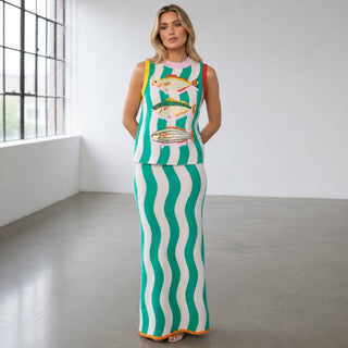 Queen of Sparkles teal midi knit skirt with green and white wave stripe pattern, pink waistband, and orange trim, front full-length view in a bright studio.
