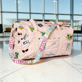 Beige quilted Queen of Sparkles duffle bag with colorful embroidered sequin travel patches and shoulder strap front full view