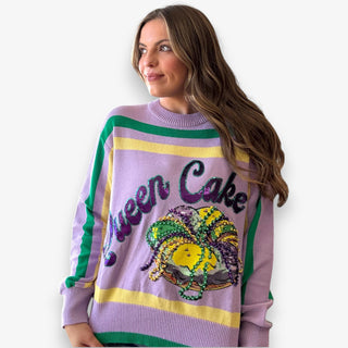 Queen of Sparkles lilac Queen Cake striped Mardi Gras sweater with sequin graphic and green and yellow trim.