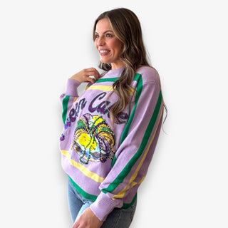 Queen of Sparkles lilac Queen Cake striped Mardi Gras sweater with sequin graphic and green and yellow trim.