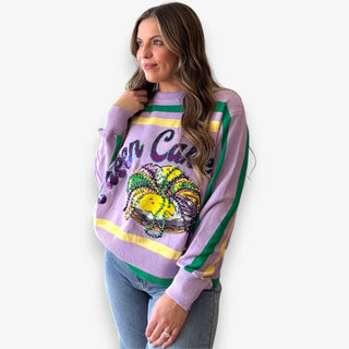 Queen of Sparkles lilac Queen Cake striped Mardi Gras sweater with sequin graphic and green and yellow trim.