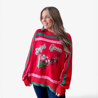 Woman wearing a red Christmas sweater with 'Sleigh Queen' text and reindeer design.
