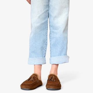 Sam Edelman Astrid Cozy Suede Mule in Warm Nutmeg shown from the front with tassel detail and light wash jeans.
