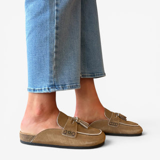 Sam Edelman Astrid suede mule in tan worn with blue jeans side view showing tassel loafer detail
