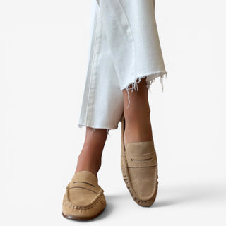 Sam Edelman Louella mule in Cyprus Tan suede worn with white cropped jeans, top view showing the penny loafer detail