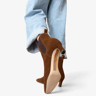 Sam Edelman Peony ankle boot in Warm Nutmeg suede shown from the sole and heel view with cuffed jeans.