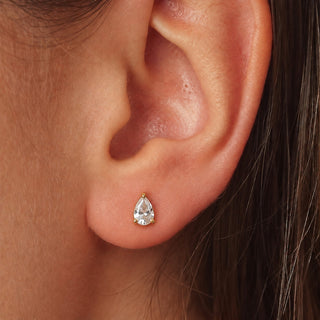  Saône 18K gold non-tarnish CZ teardrop stud earring shown on ear, close-up model view
