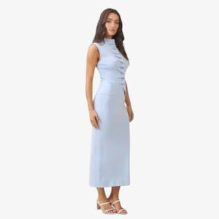 Sky blue pleated sleeveless top paired with matching pleated midi skirt worn as a coordinated set