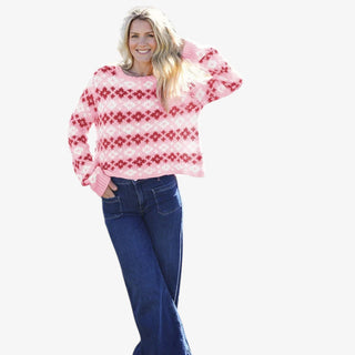 Woman wearing pink and red Fair Isle crew sweater with relaxed fit