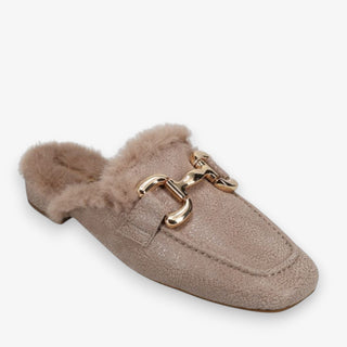 Taupe slip on mule with faux fur lining and gold buckle detailing on a white background
