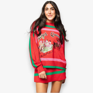 Red Queen of Sparkles Sleigh Queen Sweater featuring sequin Santa and reindeer design with pink and green striped accents, modeled on white background.