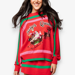 Person wearing a red Christmas-themed sweater with 'Sleigh Queen' text and festive design.