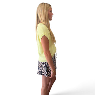 Soft yellow knit top for women showing short sleeves, lightweight knit texture and relaxed fit, side view