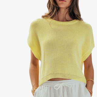     Soft yellow short sleeve knit top with relaxed boxy fit and wide sleeves, styled with white drawstring pants in a front view.