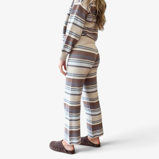 Striped sweater pant set in cream, brown and blue shown from side back, highlighting fit of straight leg knit pants