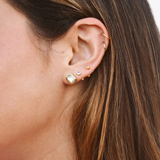 Pair of Cut Stud Earrings with geometric faceted stone and gold finish
