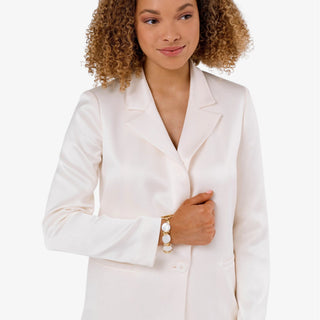 Gold and pearl statement bracelet featuring oversized coin pearls and knot details, lifestyle view