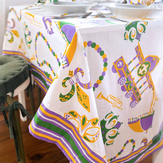 Mardi Gras-themed tablecloth and decorations on a dining table.