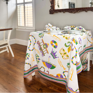 Mardi Gras-themed tablecloth and decorations on a dining table.