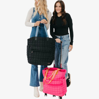 Hot pink quilted rolling tote travel bag with wheels and retractable handle carry on luggage front view