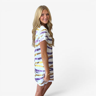 White sequin striped t-shirt dress with purple and gold tiger stripe pattern styled with sneakers, angled side view