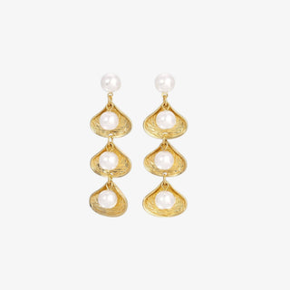 Gold earrings with pearl drops on a white background