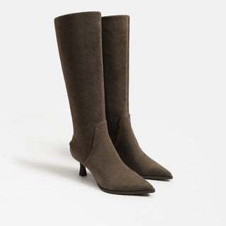 Pair of brown knee-high boots on a light gray background