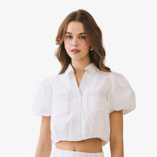 White puff sleeve crop top with pintuck detail and collared neckline styled with ivory high waisted skirt