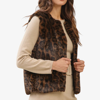 Leopard print faux fur vest with open front design styled over a beige dress