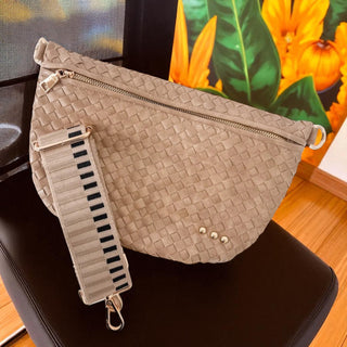 Westlyn Bum Bag in taupe woven vegan leather with gold zipper and detachable striped strap.