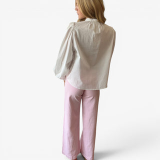 White pintuck cotton blouse showing the relaxed back, lace-trim collar and long gathered sleeves, back view