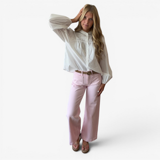 White pintuck cotton blouse with high neckline and billowy sleeves styled with pink wide-leg jeans, alternate front view
