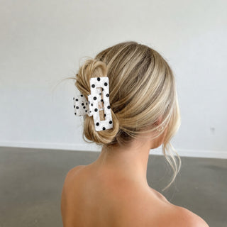 White polka dot hair claw clip in standard 3.2-inch size styled in a blonde updo, lifestyle view