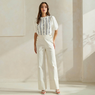 Ivory high-rise button front trousers with gold button detail and straight-leg fit